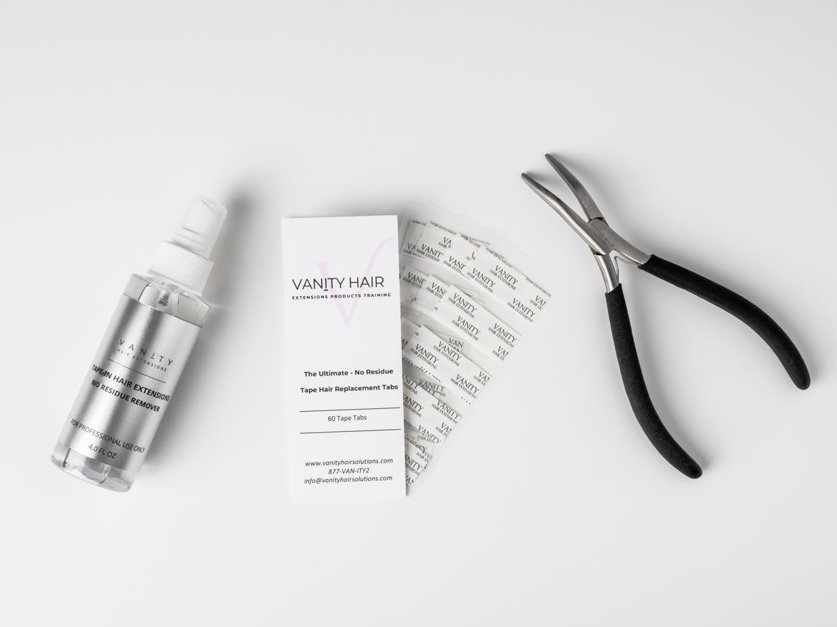 The tape extension kit laid out, remover bottle, 60-tab card and application pliers