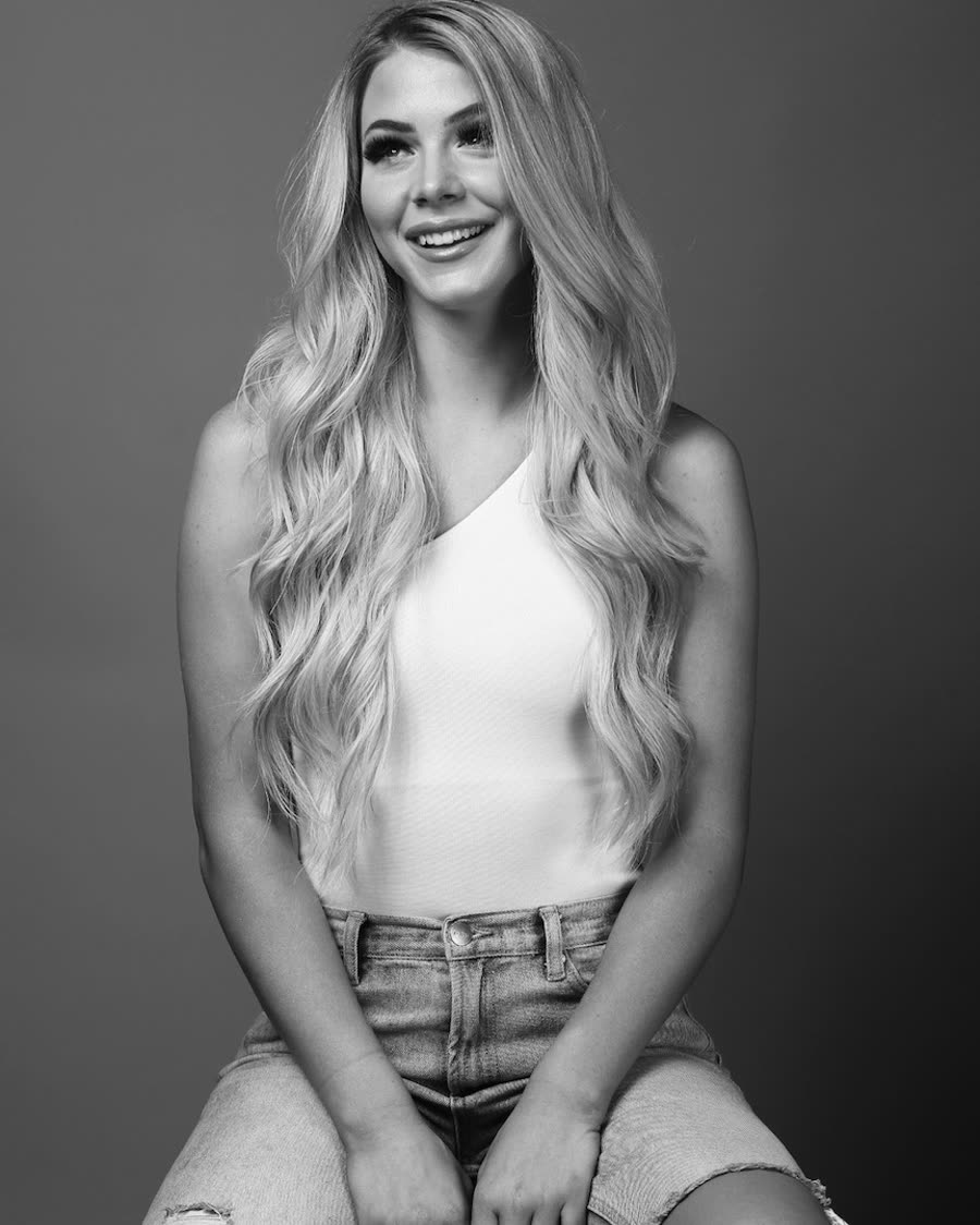Tape-in hair extensions styled long and smooth, studio portrait